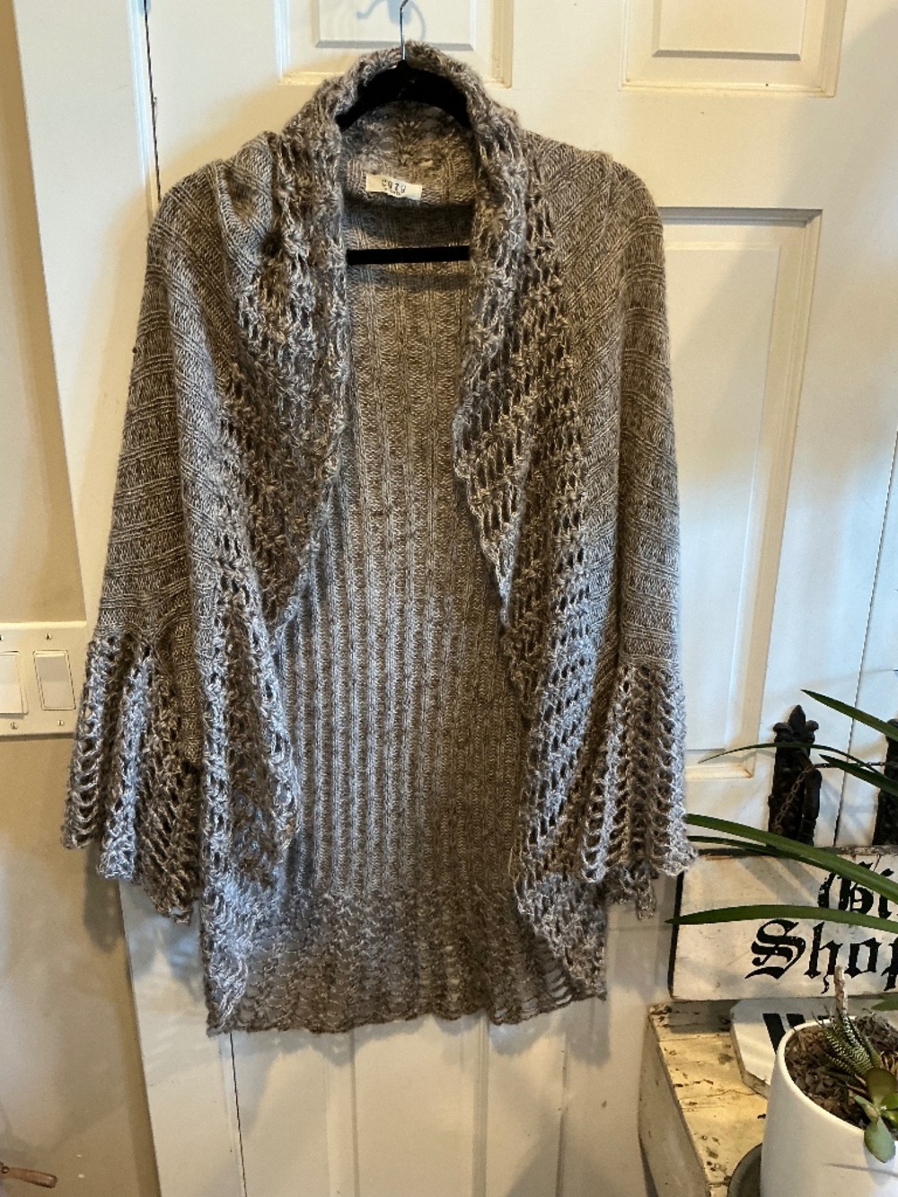 Cozy brand cardigan style sweater with wide ruffle style lapels!